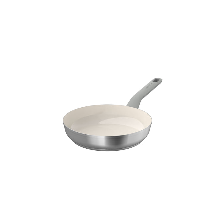 24 cm non-stick frying pan with a light-colored interior and a silver exterior, featuring a gray handle.
