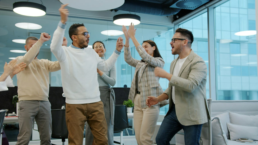 Sales team celebrating a success in the office